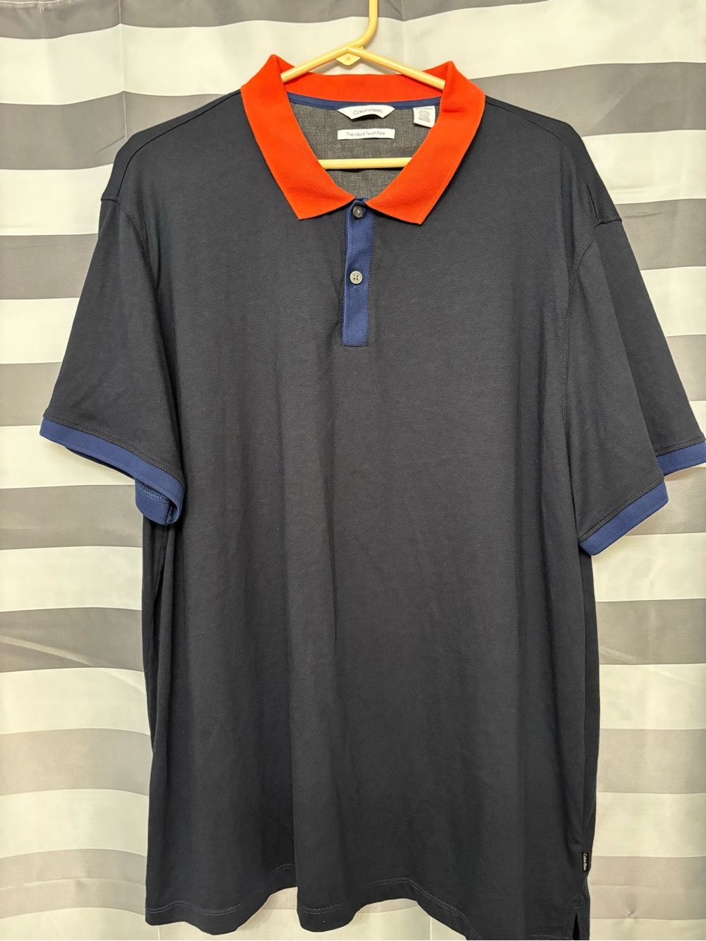 Calvin Klein Liquid Touch PoloNavy Polo with Red Collar and Blue Trim